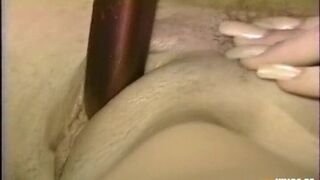 Horny Blonde Enjoys Playing with Her Bush on the Bed Using a Toy