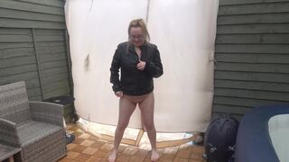 Sexy wife posing in the Yard naked in Leather coat