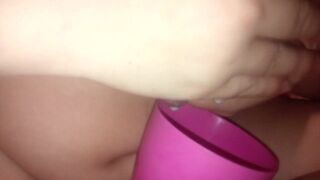 Inexperienced mom pours milk from boobs into a cup