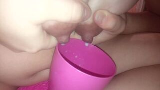 Inexperienced mom pours milk from boobs into a cup