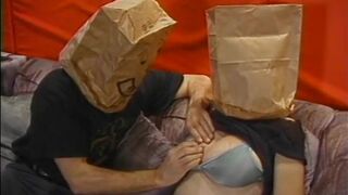 Chubby whore with paper bag on head has her jugs and cunt