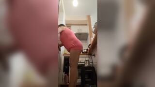 in the kitchen half-dressed