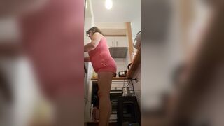 in the kitchen half-dressed