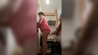 in the kitchen half-dressed