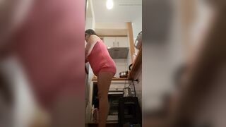 in the kitchen half-dressed