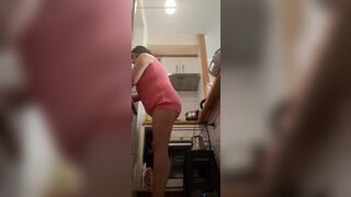 in the kitchen half-dressed