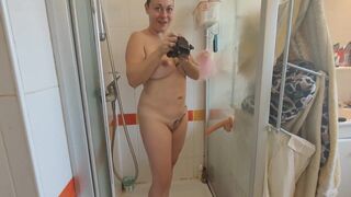 Busty milf getting ready in the shower with her dildo