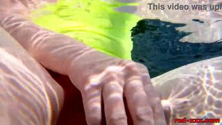 Red XXX fucks her pussy with a toy in the pool