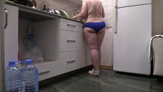 BBW MILF housewife in the kitchen wearing only panties.