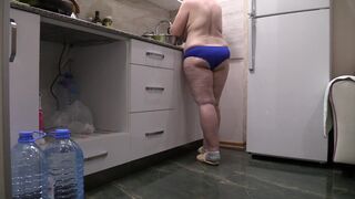 BBW MILF housewife in the kitchen wearing only panties.