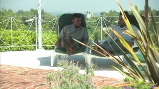 Romantic couple make out passionately by the poolside