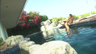 Romantic couple make out passionately by the poolside